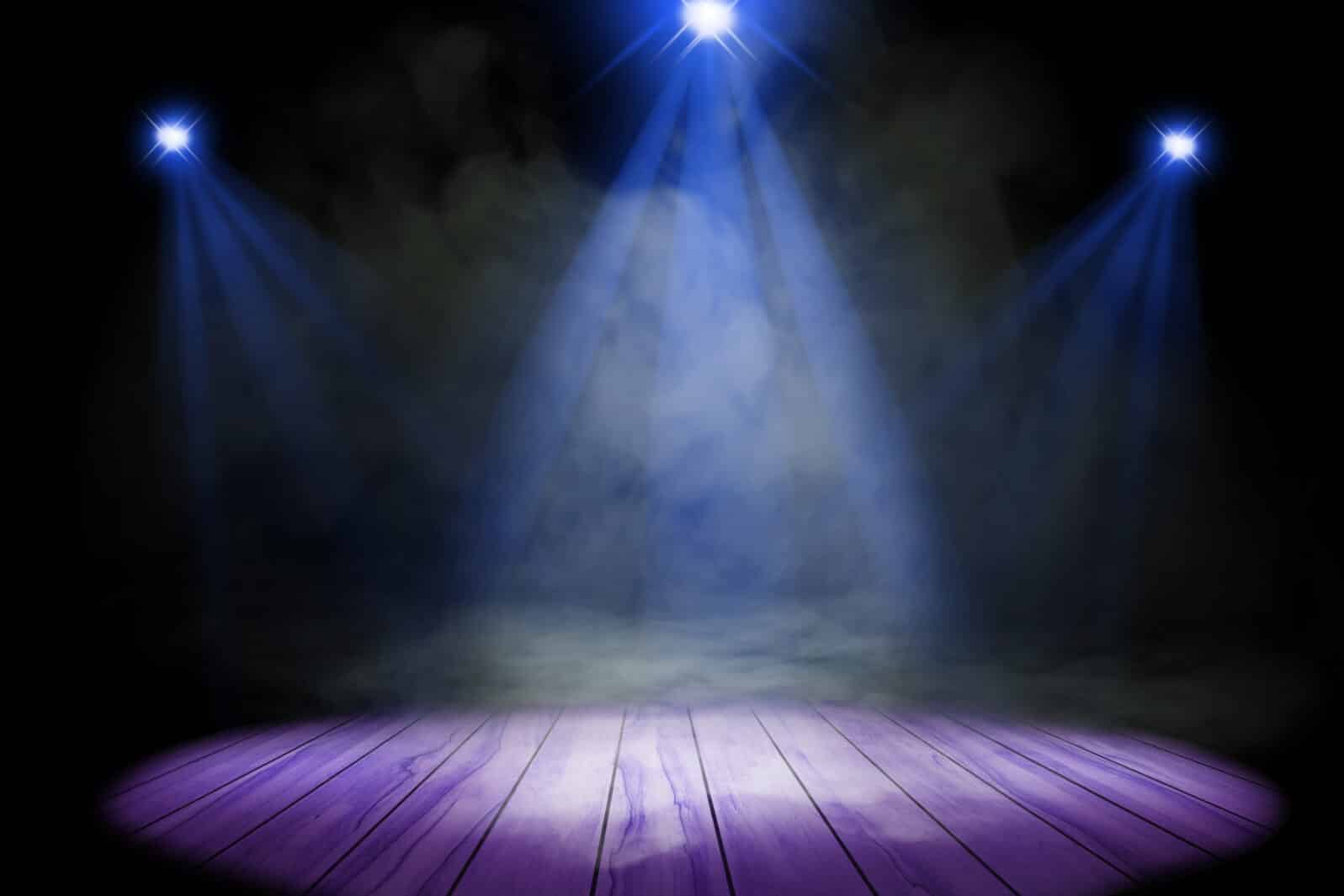 Blue purple lighting and smoke on stage with floor wood