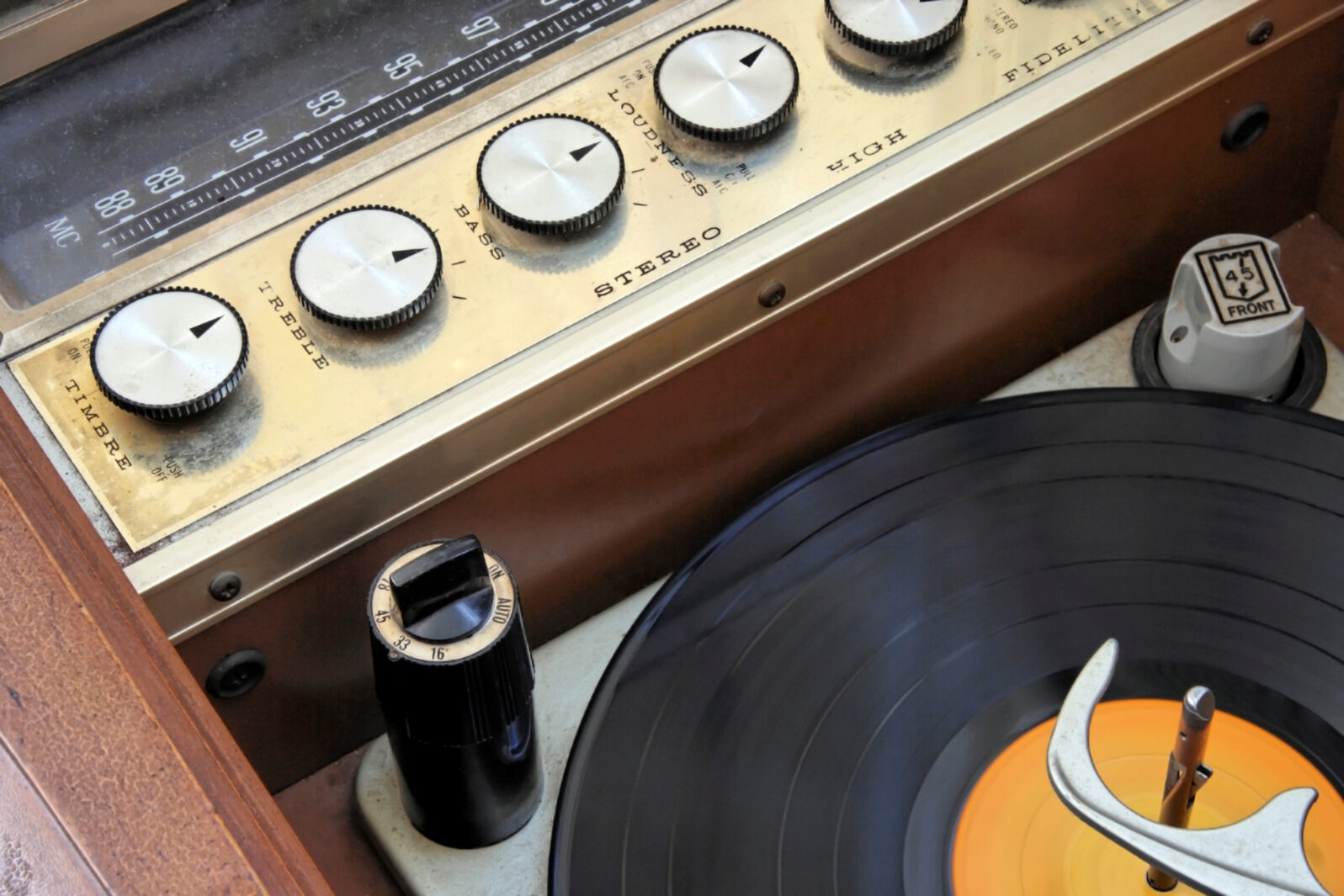 Vintage 1950 1960 hi-fi stereo radio console with lp record.