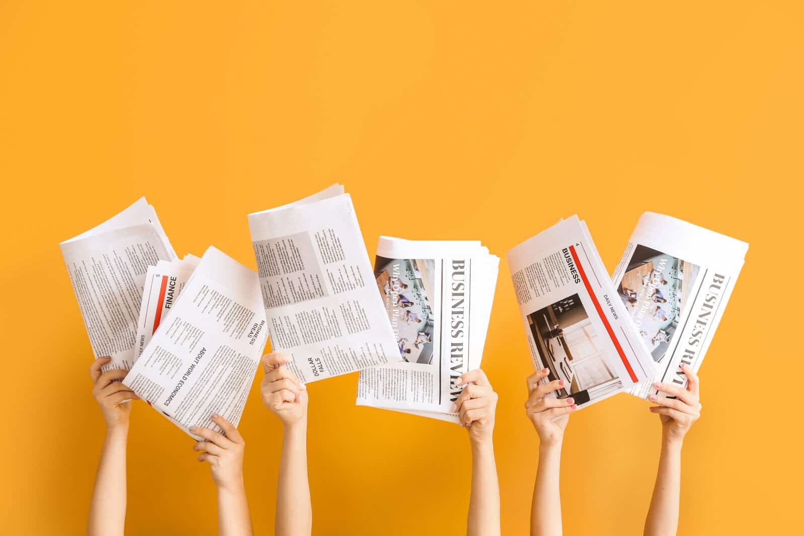 Female hands with newspapers on color background