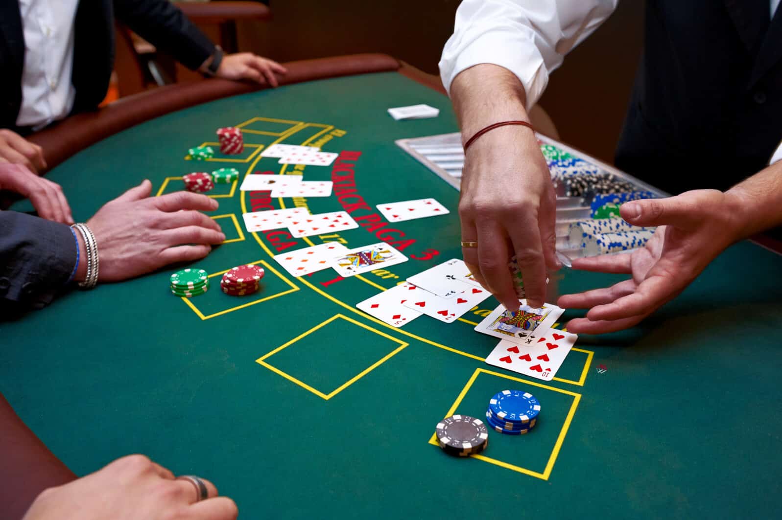 A close up of a blackjack dealer's hands in a casino, very shallow depth of field