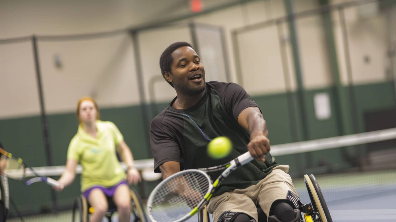 Adaptive Tennis Fun: Person with Spina Bifida Enjoys Game with Friends at Indoor Court