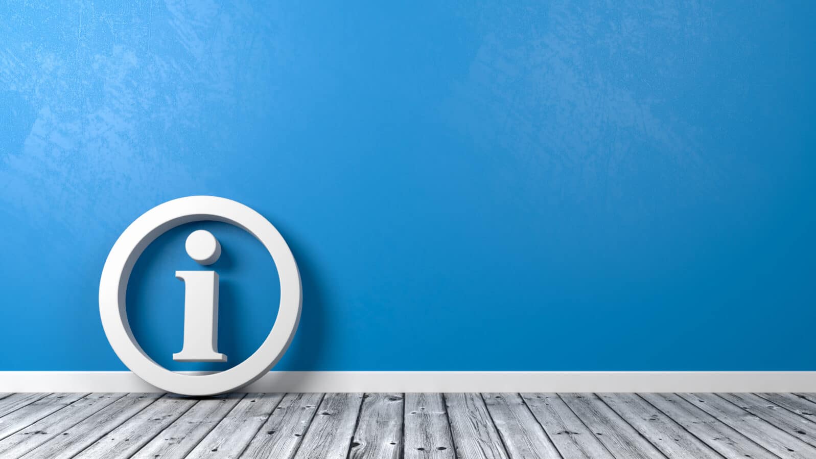 Information Symbol on Wooden Floor Against Wall
