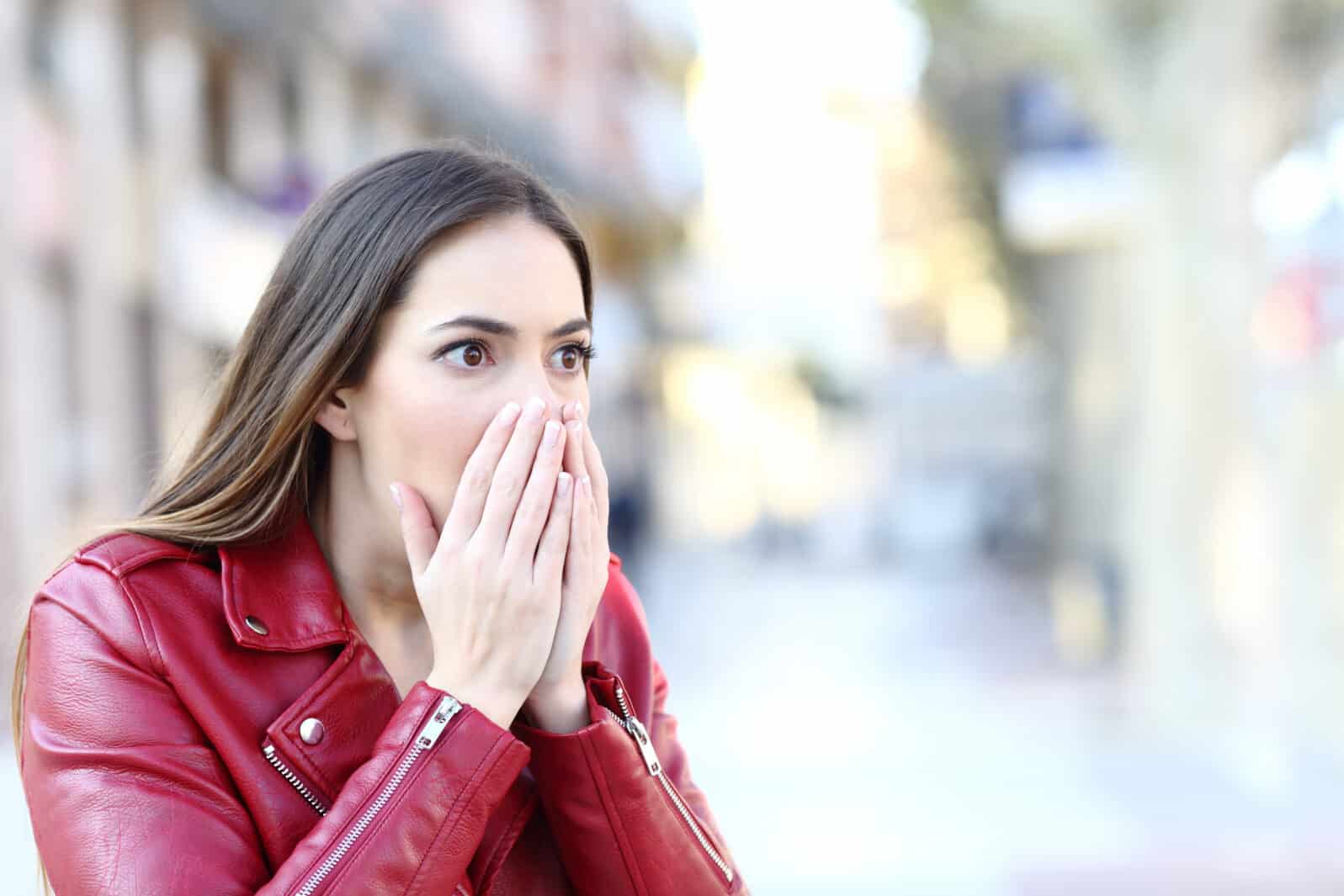 Shocked woman looking away in the street