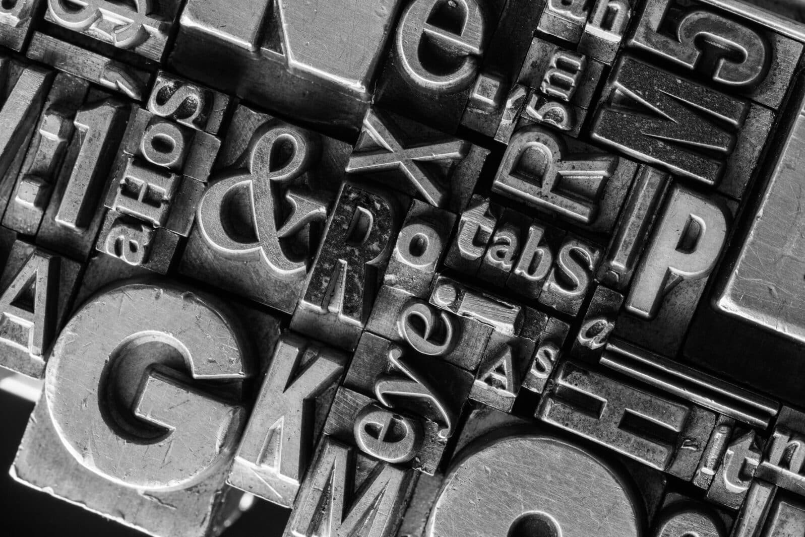 Metal Letterpress Types. A background from many historical typography letters in black and white with white background.