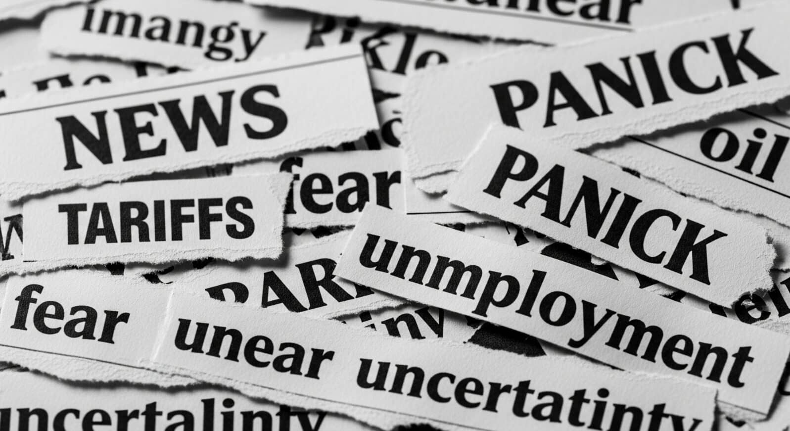 Closeup shot of torn newspaper clippings with headlines like news tariffs panic and unemployment words visible