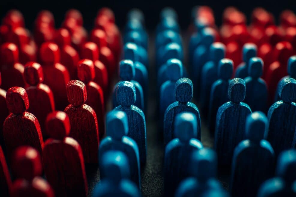 Red and blue wooden figures facing each other in contrast, representing the opposing sides in American politics or ideologies.